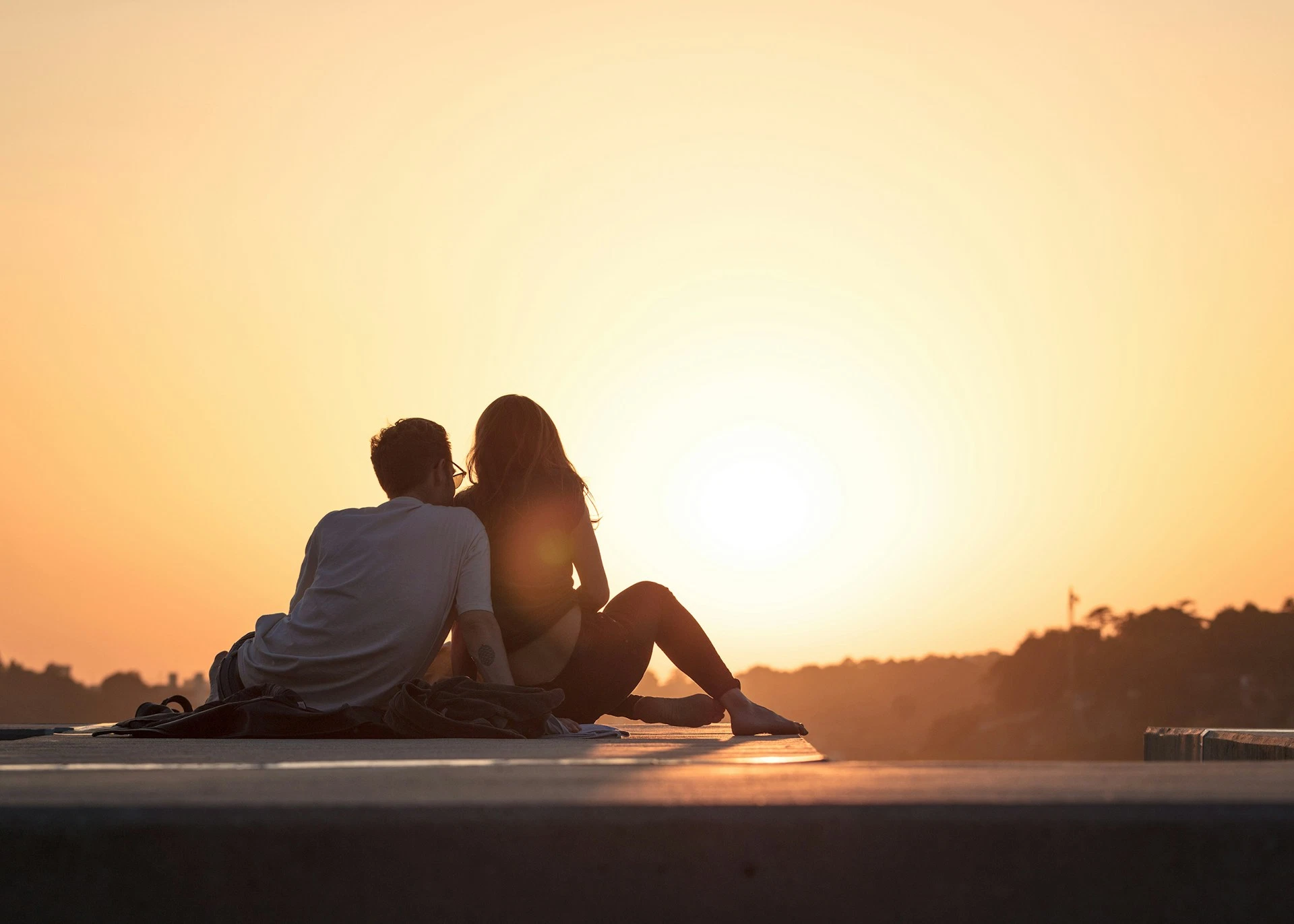 Couple enjoying a romantic sunset holiday together